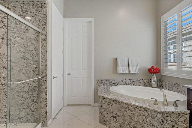 3155 Dalmazia Ave, Henderson, NV 89044 - bathroom with a shower stall, healthy amount of natural light, a garden tub, and tile patterned floors