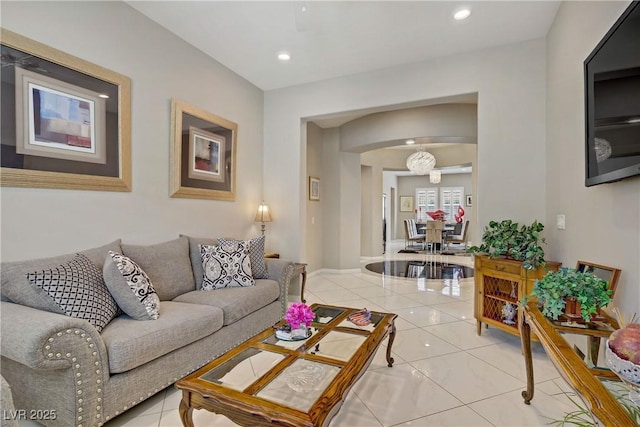 3155 Dalmazia Ave, Henderson, NV 89044 - living area featuring light tile patterned floors, arched walkways, recessed lighting, and baseboards