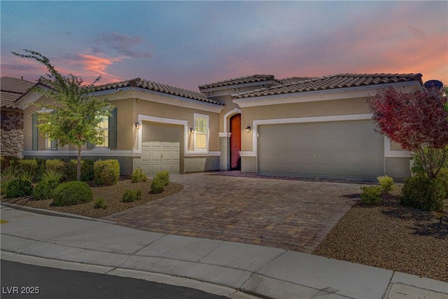3155 Dalmazia Ave, Henderson, NV 89044 - mediterranean / spanish-style home with decorative driveway, a garage, stucco siding, and a tiled roof