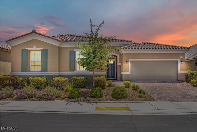 3155 Dalmazia Ave, Henderson, NV 89044 - mediterranean / spanish house with an attached garage, stucco siding, and decorative driveway