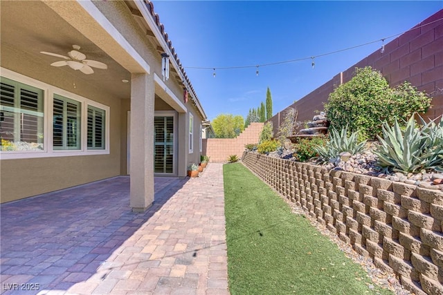 3155 Dalmazia Ave, Henderson, NV 89044 - fenced backyard featuring a ceiling fan and a patio area