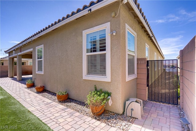 3155 Dalmazia Ave, Henderson, NV 89044 - view of property exterior featuring stucco siding, a gate, and a patio