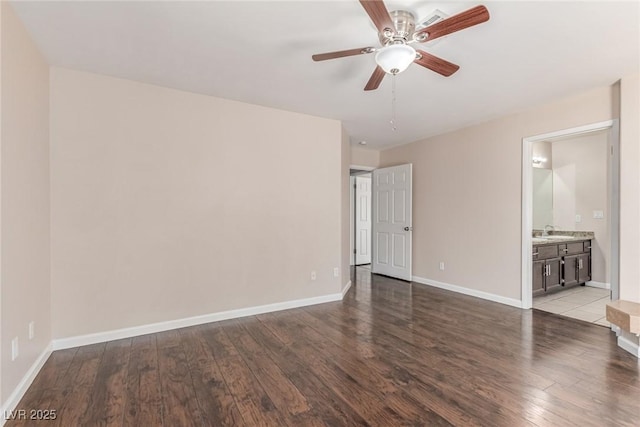 9305 Hollycrest Dr, Las Vegas, NV 89117 - unfurnished bedroom with wood-type flooring, a sink, baseboards, and ensuite bath