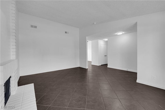 6791 Greengrove Dr, Las Vegas, NV 89103 - empty room with dark tile patterned floors, a textured ceiling, and baseboards