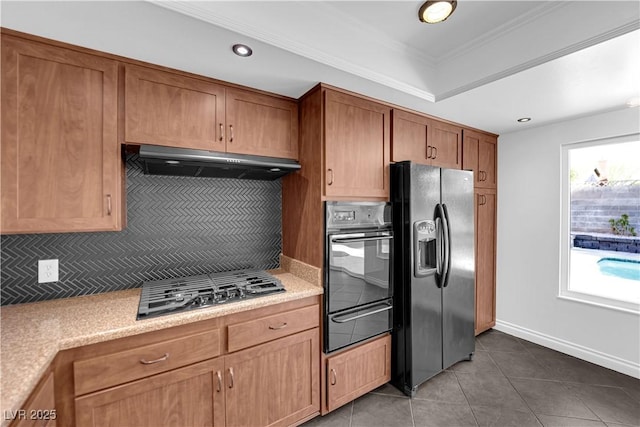 6791 Greengrove Dr, Las Vegas, NV 89103 - kitchen with fridge with ice dispenser, black oven, a warming drawer, under cabinet range hood, and stainless steel gas stovetop