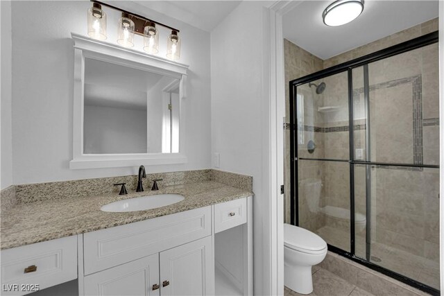 6791 Greengrove Dr, Las Vegas, NV 89103 - full bathroom featuring toilet, a shower stall, vanity, and tile patterned floors