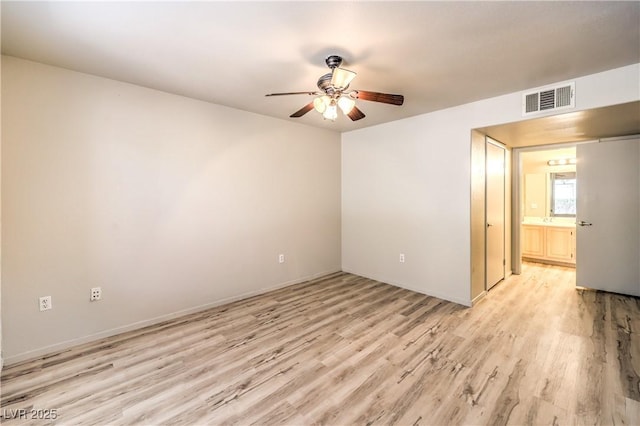 5710 E Tropicana Ave Unit 1114, Las Vegas, NV 89122 - unfurnished room featuring light wood-style flooring, a ceiling fan, and baseboards