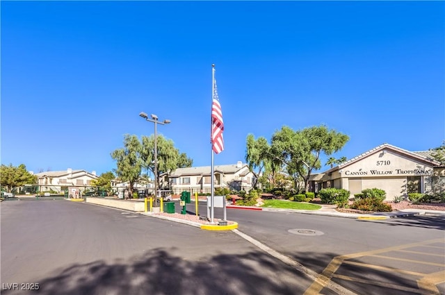 5710 E Tropicana Ave Unit 1114, Las Vegas, NV 89122 - view of asphalt street featuring curbs, a residential view, and a gated entry
