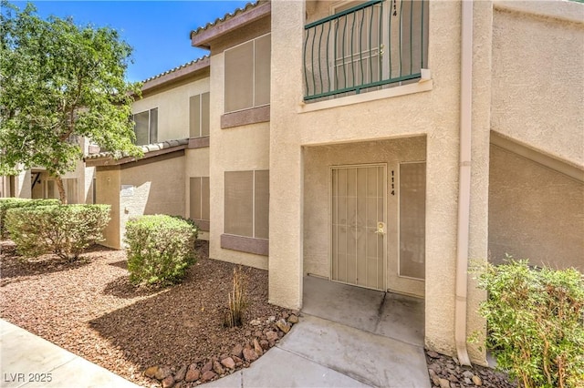 5710 E Tropicana Ave Unit 1114, Las Vegas, NV 89122 - property entrance with stucco siding and a tile roof