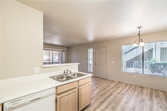 5710 E Tropicana Ave Unit 1114, Las Vegas, NV 89122 - kitchen with dishwasher, a sink, light brown cabinetry, light wood finished floors, and light countertops