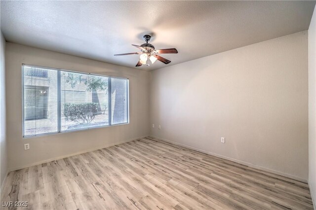 5710 E Tropicana Ave Unit 1114, Las Vegas, NV 89122 - empty room with ceiling fan, light wood finished floors, and baseboards