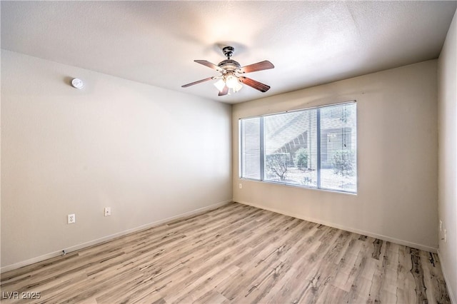 5710 E Tropicana Ave Unit 1114, Las Vegas, NV 89122 - unfurnished room featuring a ceiling fan, light wood-style floors, a smoke detector, baseboards, and a textured ceiling