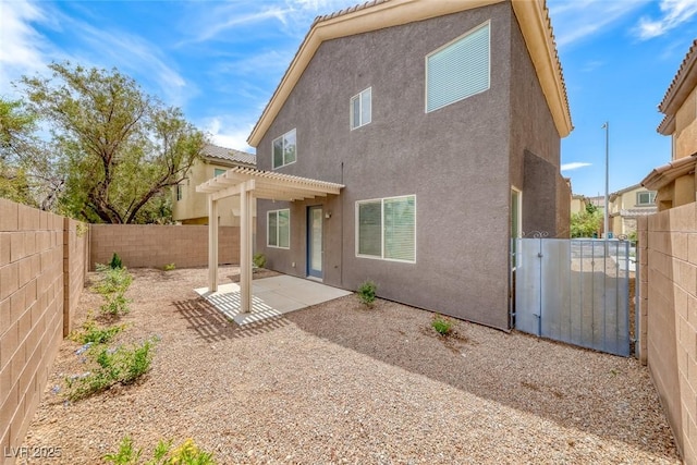 9766 Marcelline Ave, Las Vegas, NV 89148 - back of house featuring stucco siding, a pergola, a fenced backyard, a patio area, and a gate