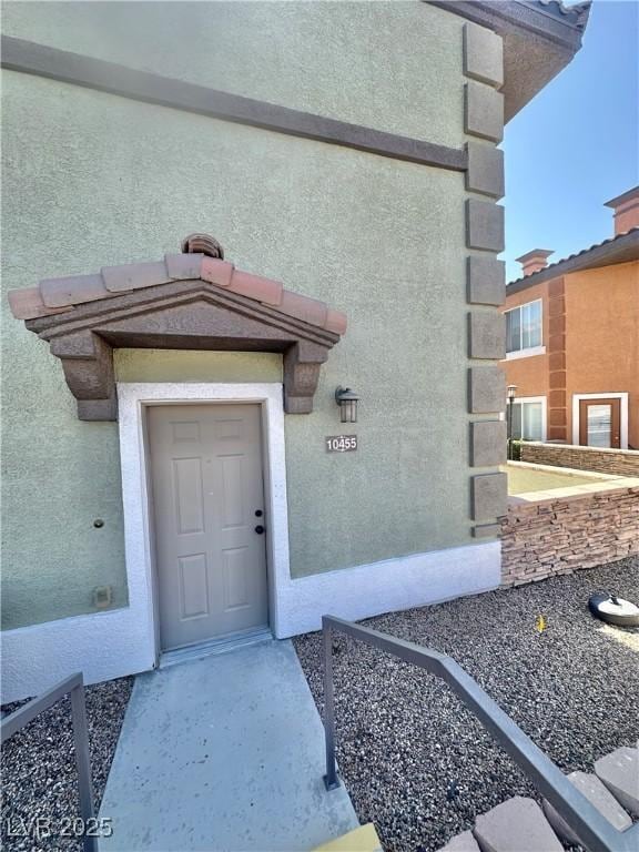 10455 Alpine Edge Ave, Las Vegas, NV 89129 - doorway to property featuring stucco siding