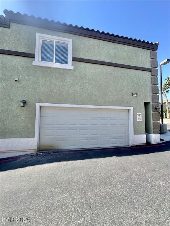 10455 Alpine Edge Ave, Las Vegas, NV 89129 - view of home's exterior with stucco siding and a garage