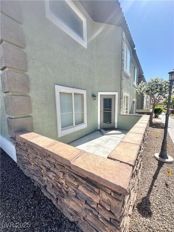 10455 Alpine Edge Ave, Las Vegas, NV 89129 - rear view of house with stucco siding and a patio area