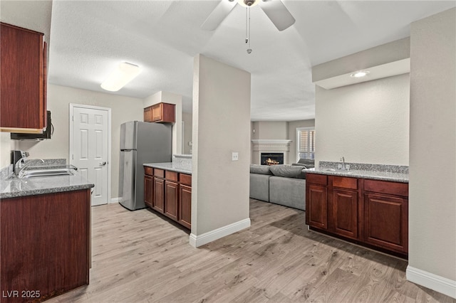 2606 S Durango Dr Unit 245, Las Vegas, NV 89117 - kitchen with a sink, freestanding refrigerator, and light wood-style floors