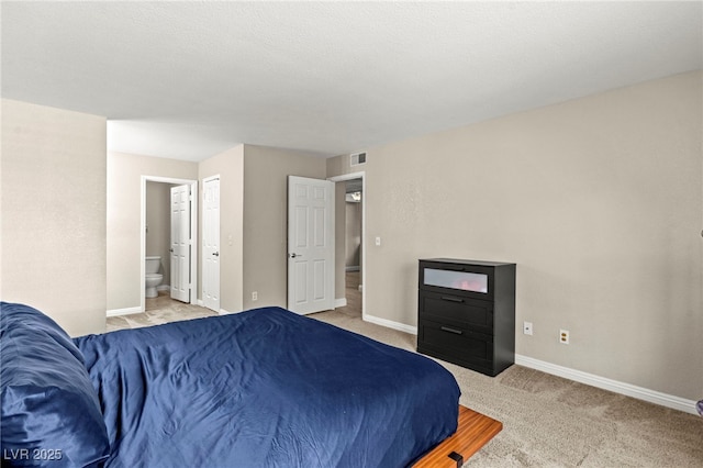 2606 S Durango Dr Unit 245, Las Vegas, NV 89117 - bedroom with light colored carpet, connected bathroom, and baseboards