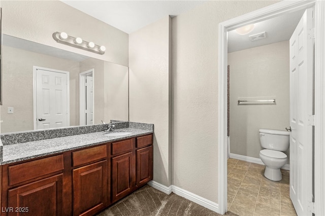 2606 S Durango Dr Unit 245, Las Vegas, NV 89117 - bathroom featuring vanity, toilet, and baseboards