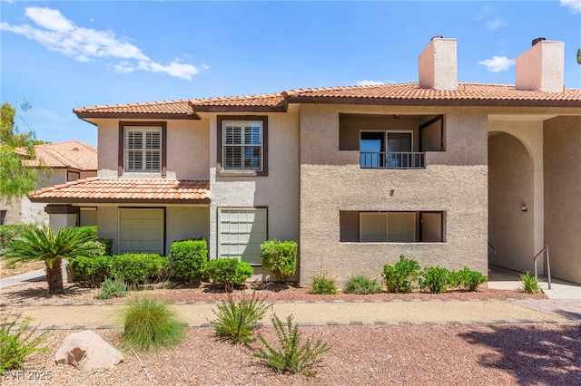 2606 S Durango Dr Unit 245, Las Vegas, NV 89117 - mediterranean / spanish house featuring stucco siding, a chimney, and a tiled roof