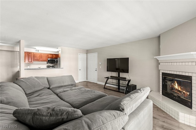 2606 S Durango Dr Unit 245, Las Vegas, NV 89117 - living room with a brick fireplace, light wood finished floors, and baseboards