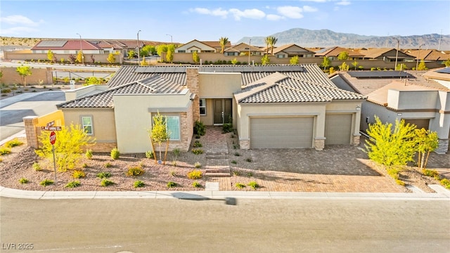 10906 Mila Landing Ave, Las Vegas, NV 89166 - view of front of home with a tiled roof, an attached garage, a residential view, and stucco siding
