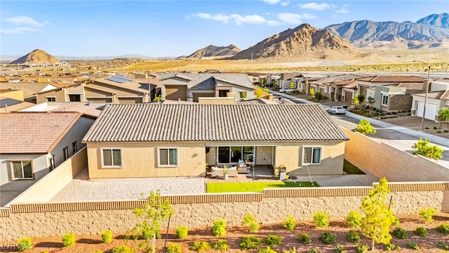 10906 Mila Landing Ave, Las Vegas, NV 89166 - rear view of house featuring a residential view, a fenced backyard, stucco siding, and a mountain view