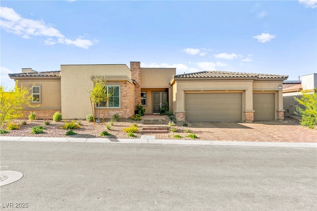 10906 Mila Landing Ave, Las Vegas, NV 89166 - view of front of house featuring an attached garage, driveway, and stucco siding
