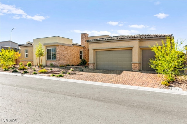 10906 Mila Landing Ave, Las Vegas, NV 89166 - view of front of home with stucco siding, a tile roof, decorative driveway, an attached garage, and stone siding