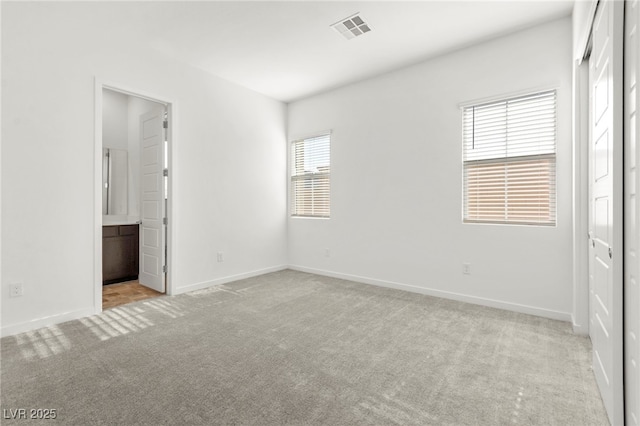 10906 Mila Landing Ave, Las Vegas, NV 89166 - unfurnished bedroom featuring carpet floors, baseboards, and ensuite bathroom