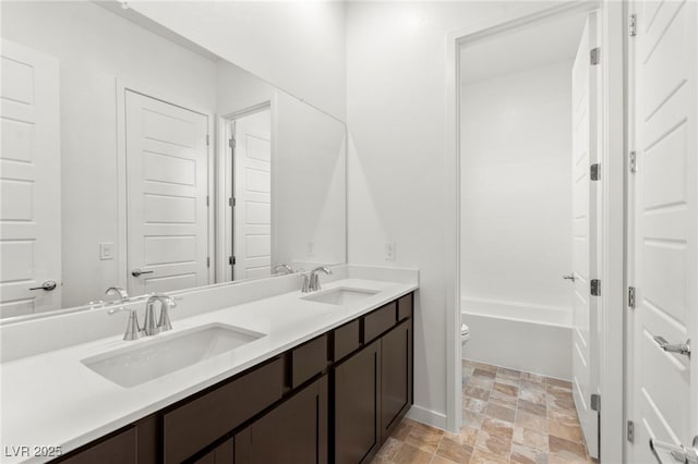 10906 Mila Landing Ave, Las Vegas, NV 89166 - bathroom with toilet, double vanity, and stone finish floors