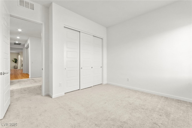10906 Mila Landing Ave, Las Vegas, NV 89166 - unfurnished bedroom with light carpet, a closet, baseboards, and recessed lighting