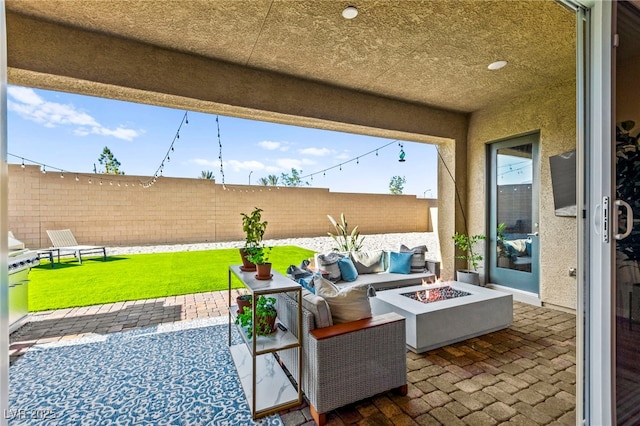 10906 Mila Landing Ave, Las Vegas, NV 89166 - fenced backyard featuring a patio area and an outdoor living space with a fire pit