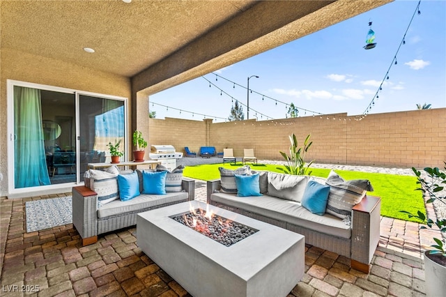 10906 Mila Landing Ave, Las Vegas, NV 89166 - fenced backyard featuring a patio, an outdoor living space with a fire pit, and area for grilling