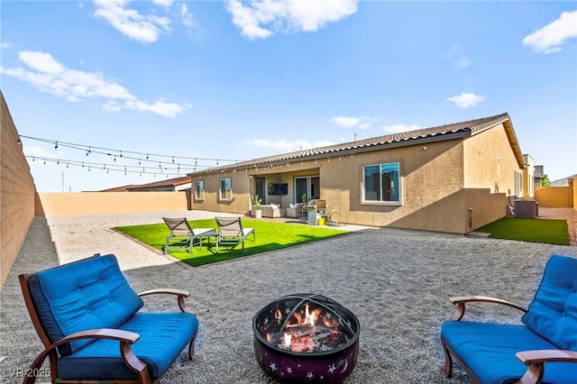 10906 Mila Landing Ave, Las Vegas, NV 89166 - rear view of house with an outdoor fire pit, central AC unit, stucco siding, and a fenced backyard