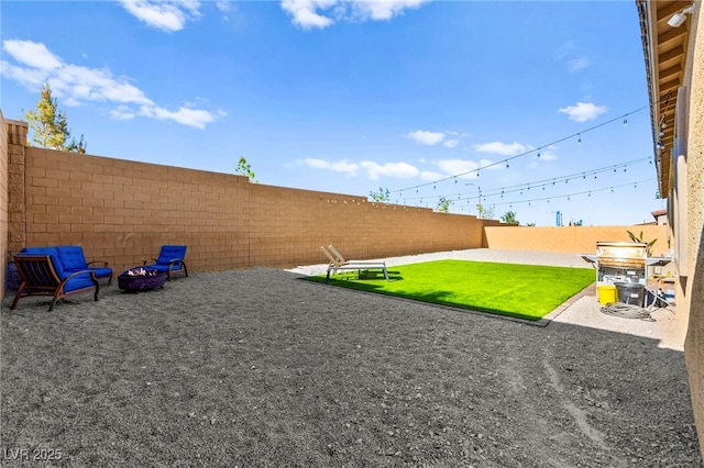 10906 Mila Landing Ave, Las Vegas, NV 89166 - fenced backyard with an outdoor fire pit and a patio area