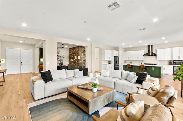 10906 Mila Landing Ave, Las Vegas, NV 89166 - living room with light wood-type flooring and recessed lighting