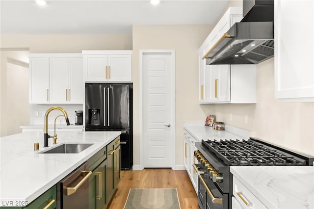 10906 Mila Landing Ave, Las Vegas, NV 89166 - kitchen featuring stainless steel appliances, wall chimney exhaust hood, a sink, white cabinetry, and recessed lighting