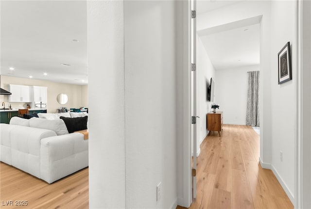 10906 Mila Landing Ave, Las Vegas, NV 89166 - hall with light wood finished floors, a sink, recessed lighting, and baseboards