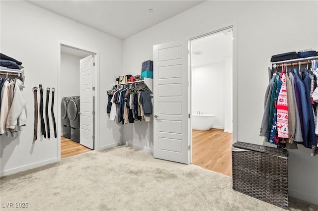 10906 Mila Landing Ave, Las Vegas, NV 89166 - walk in closet with washing machine and dryer and carpet flooring