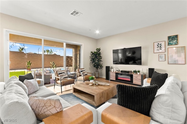 10906 Mila Landing Ave, Las Vegas, NV 89166 - living room with wood finished floors, recessed lighting, and a glass covered fireplace