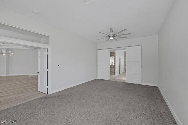 10113 Plomosa Pl, Las Vegas, NV 89134 - carpeted spare room with a barn door, a ceiling fan, and baseboards