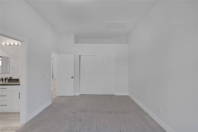10113 Plomosa Pl, Las Vegas, NV 89134 - unfurnished bedroom with light carpet, ensuite bathroom, a closet, and baseboards