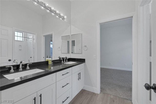 10113 Plomosa Pl, Las Vegas, NV 89134 - bathroom with double vanity, wood finished floors, and baseboards