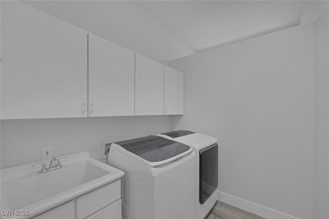 10113 Plomosa Pl, Las Vegas, NV 89134 - washroom with cabinet space, baseboards, separate washer and dryer, and light wood finished floors