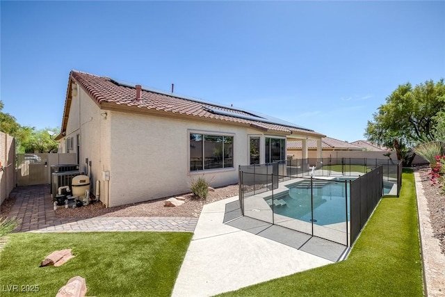 10113 Plomosa Pl, Las Vegas, NV 89134 - back of house featuring stucco siding, a tile roof, roof mounted solar panels, and a patio