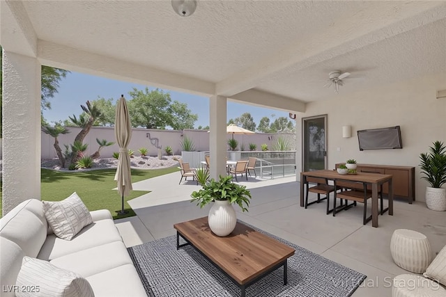10113 Plomosa Pl, Las Vegas, NV 89134 - fenced backyard featuring an outdoor hangout area, outdoor dining area, a patio, and a ceiling fan