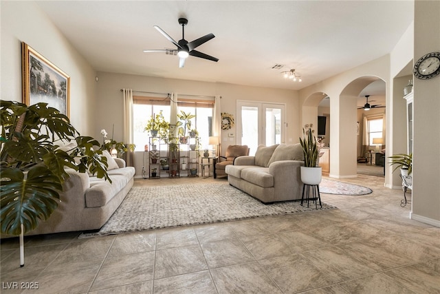 1413 Gentle Brook St, North Las Vegas, NV 89084 - living area with a ceiling fan, arched walkways, plenty of natural light, and baseboards