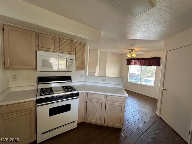 698 S Racetrack Rd Unit 1411, Henderson, NV 89015 - kitchen featuring white appliances, a peninsula, light countertops, dark wood-style flooring, and a ceiling fan