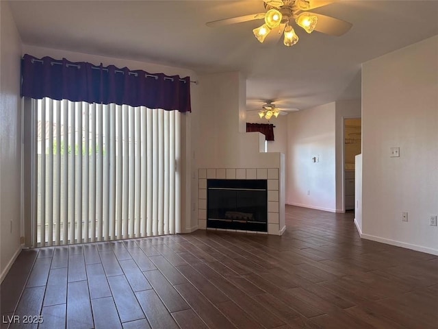 698 S Racetrack Rd Unit 1411, Henderson, NV 89015 - unfurnished living room with ceiling fan, baseboards, dark wood-style floors, and a tiled fireplace